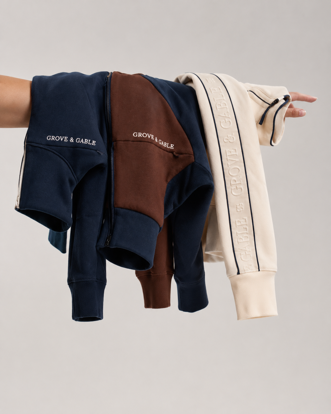 Grove & Gable Season 01 quarter-zip sweaters in navy, chocolate and cream with contrast taping