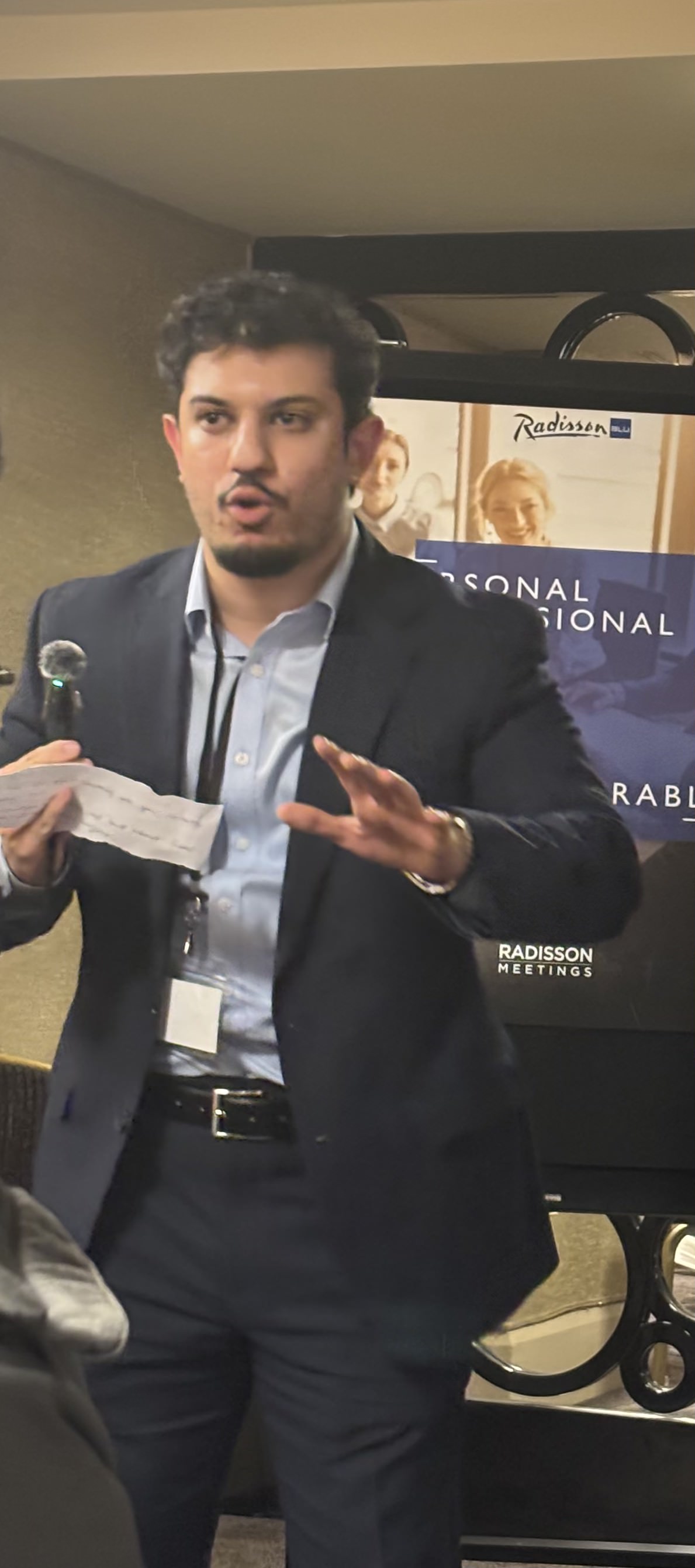 Umar Khokhar speaking at a live event