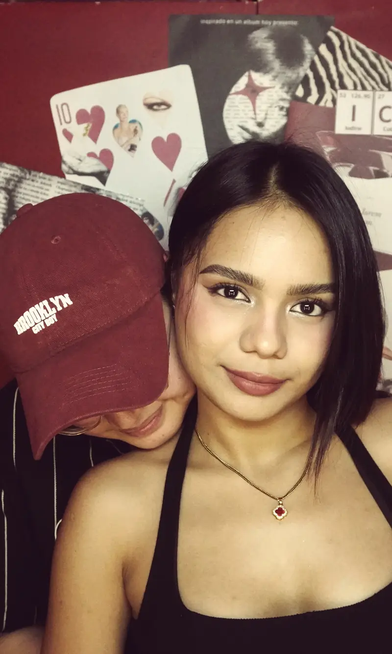 A guest in a Brooklyn cap with a friend behind her at Big House