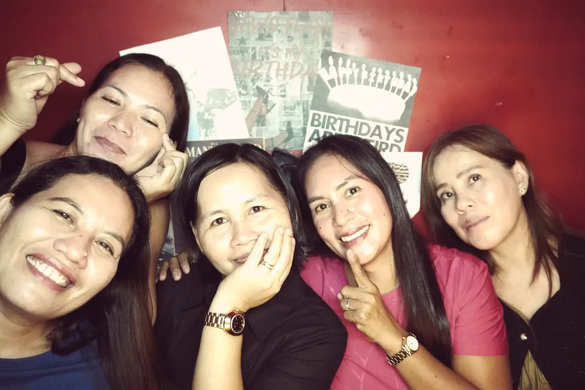 Five friends squeezed into the frame at a birthday party