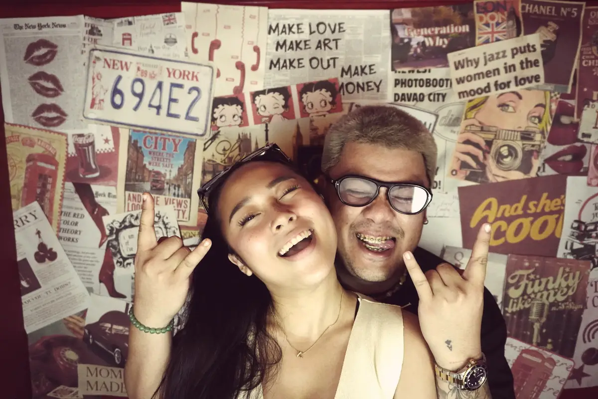 A couple laughing in the booth at Sandera Weekend Market