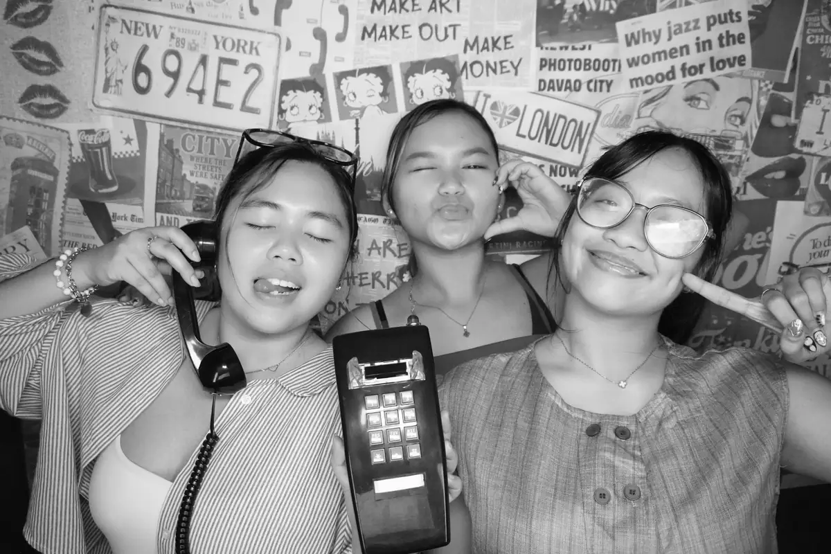 Three friends with the booth phones at Sandera