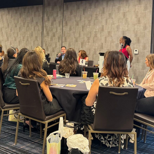 Automotive professionals building mentoring relationships through collaborative discussion