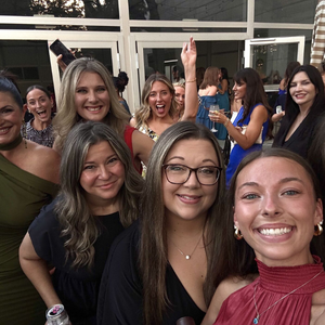 Women welcoming a first-time attendee into the Women In Automotive community