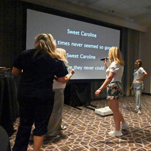 Women connecting during a social event at the 2026 Women In Automotive Conference