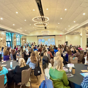 Women connecting at connecting with fellow automotive professionals at a Women In Automotive conference. Women connecting at connecting with fellow automotive professionals at a Women In Automotive conference.