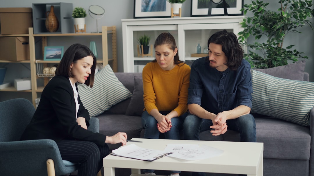 Buyers discussing options with an agent while looking thoughtful or uncertain.
