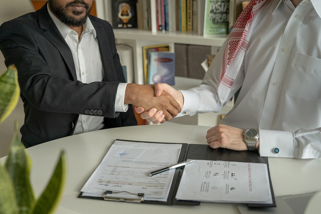 Successful agent shaking hands with happy clients after a smooth transaction.