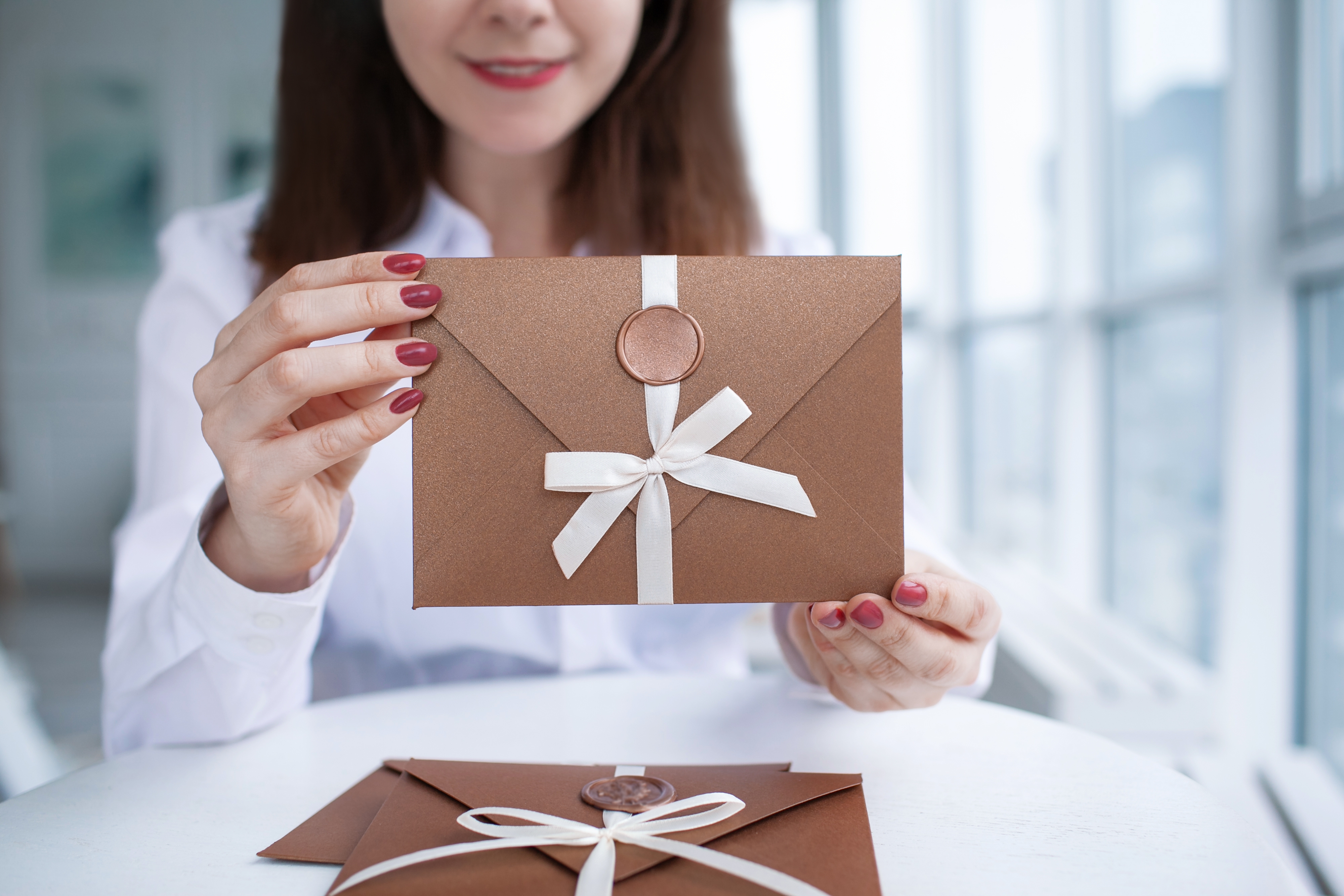 real estate agent sending handwritten notes, delivering a client gift, or attending a client appreciation event.
