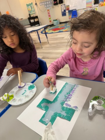 A teacher working closely with young students