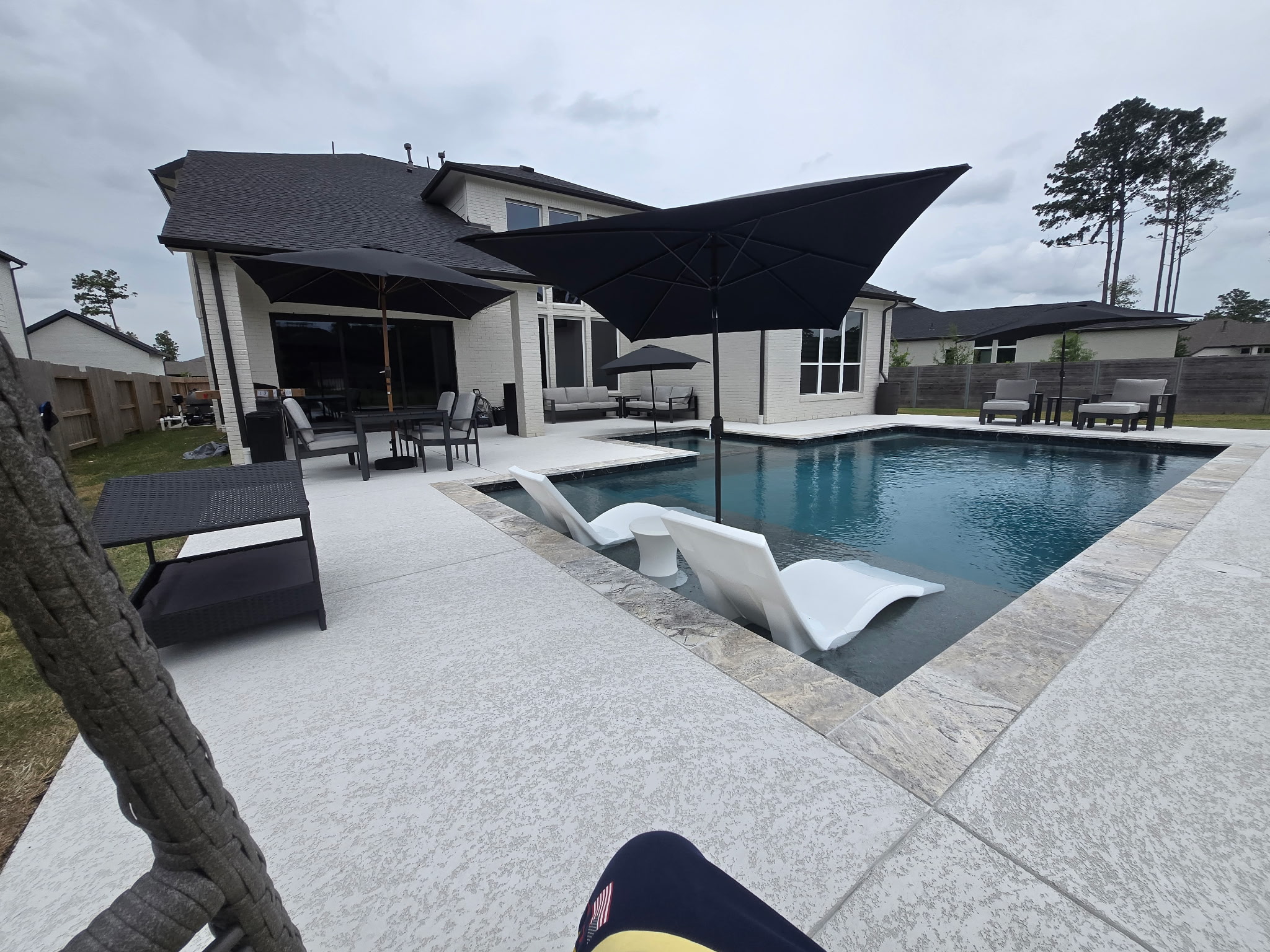 Wood pergola over a poolside patio
