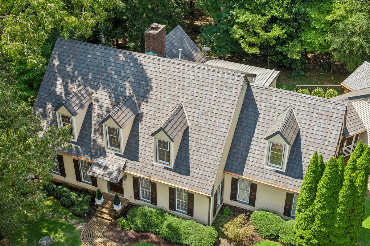 Brava composite cedar shake roof on a shingle-style estate with multiple dormers