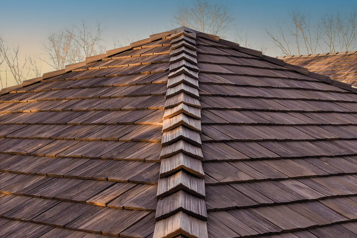 Detail of Brava composite cedar shake in a warm brown tone on a hip roof