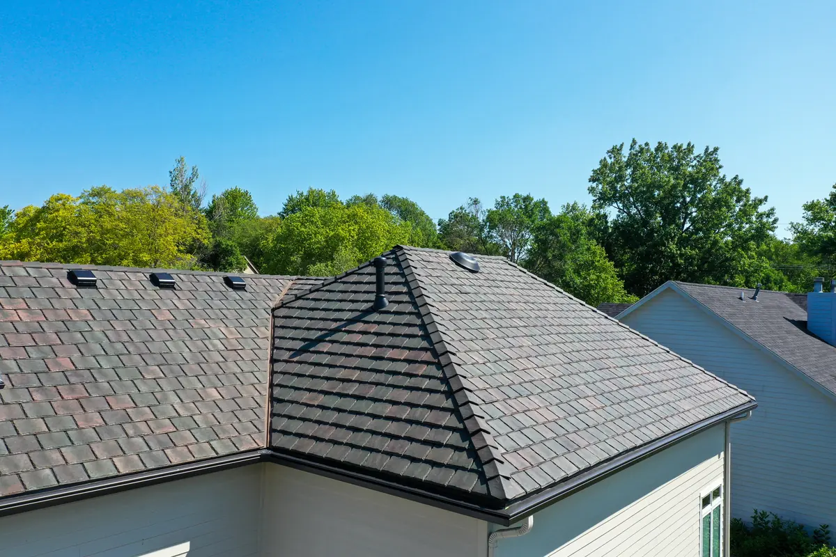 Brava synthetic slate on a hip roof, shown close against clear sky