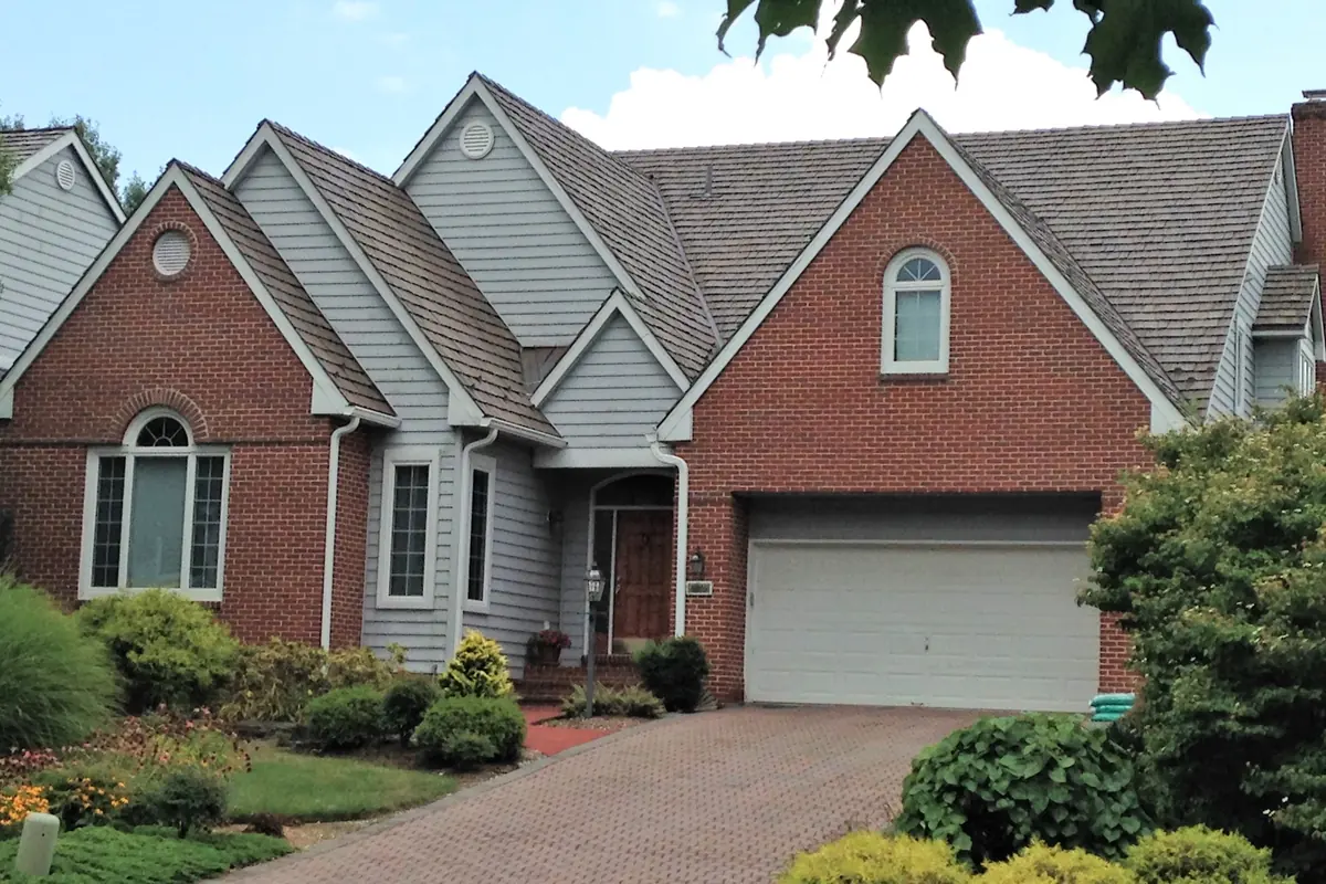 Brava composite cedar shake roof on a brick and siding traditional home