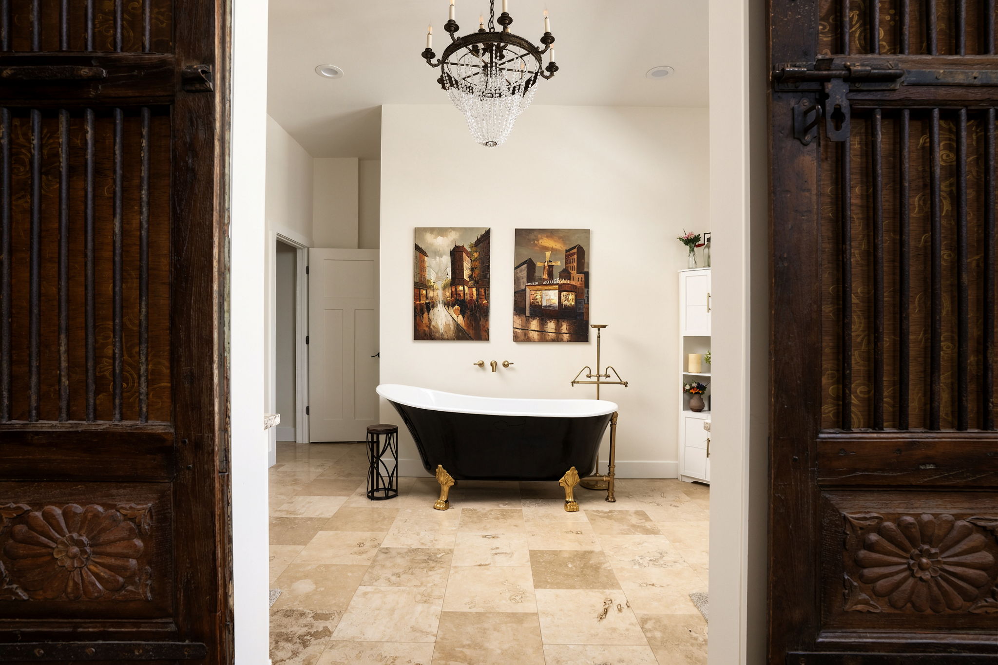 The Signature Perspective: the same tub shot through the room's ornate double doors, framed with depth