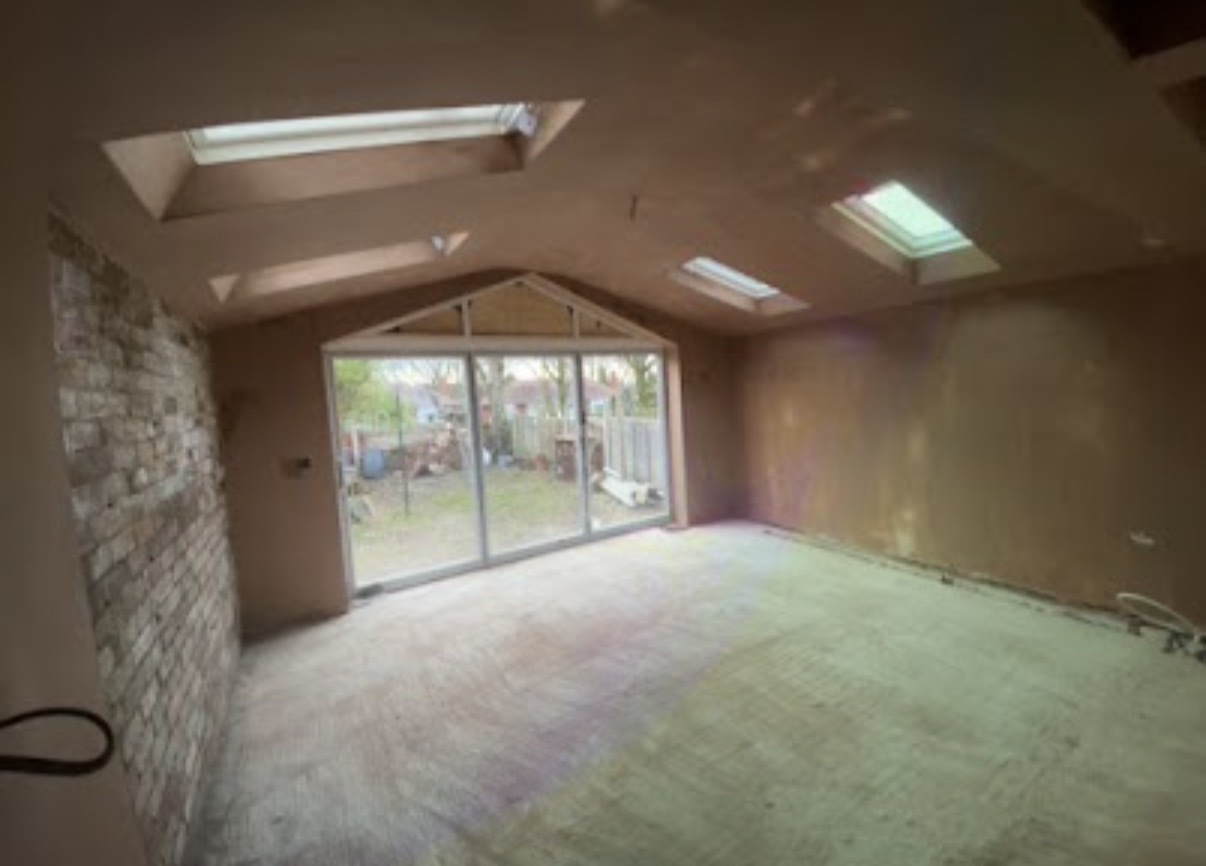Freshly plastered interior wall with a smooth skim finish