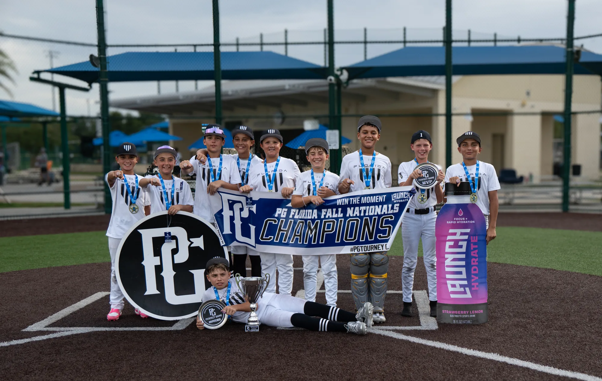 Florida Hype 11U with the 2026 PG Fall Nationals championship banner and trophy