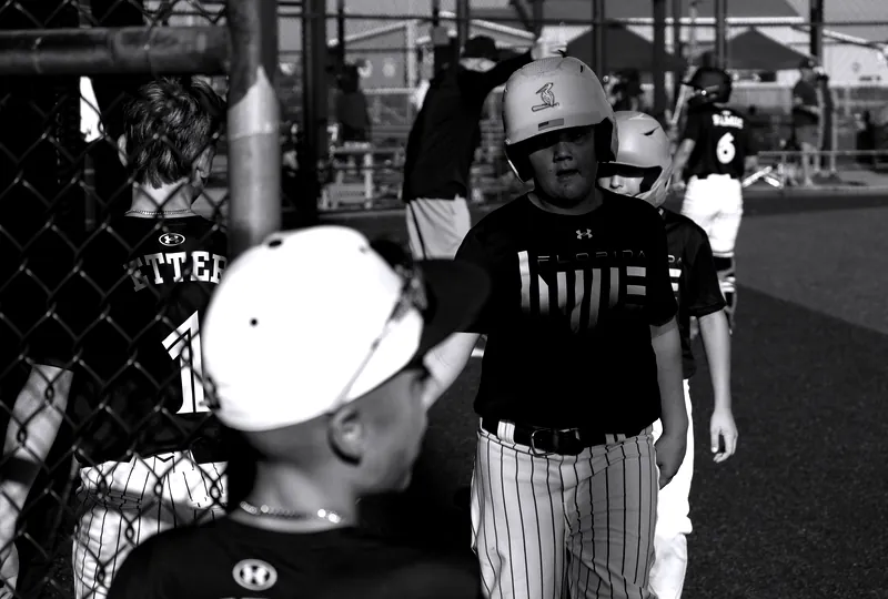 Florida Hype players at the dugout fence