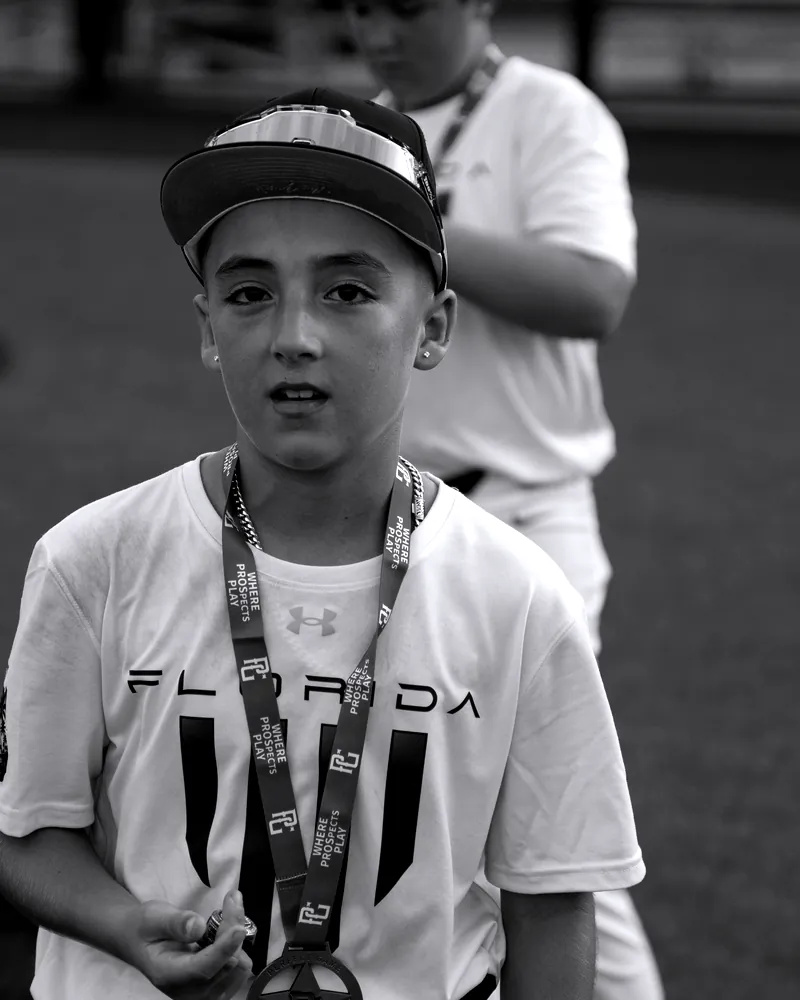 A Florida Hype player wearing his tournament medal