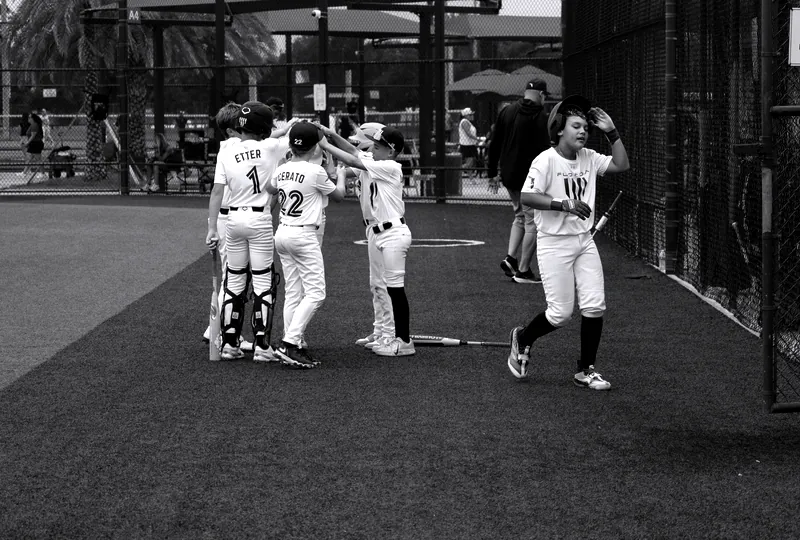 The team lines up for high-fives outside the dugout