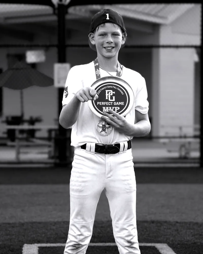 Owen Etter holds the Perfect Game tournament MVP plaque