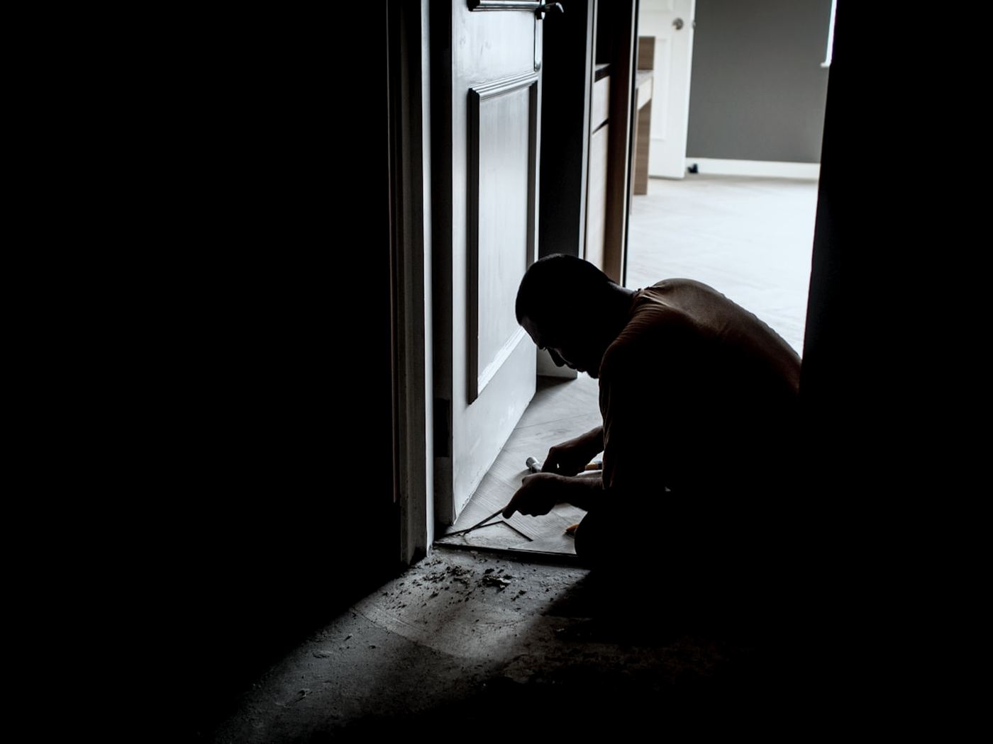 Installer working at the base of a door