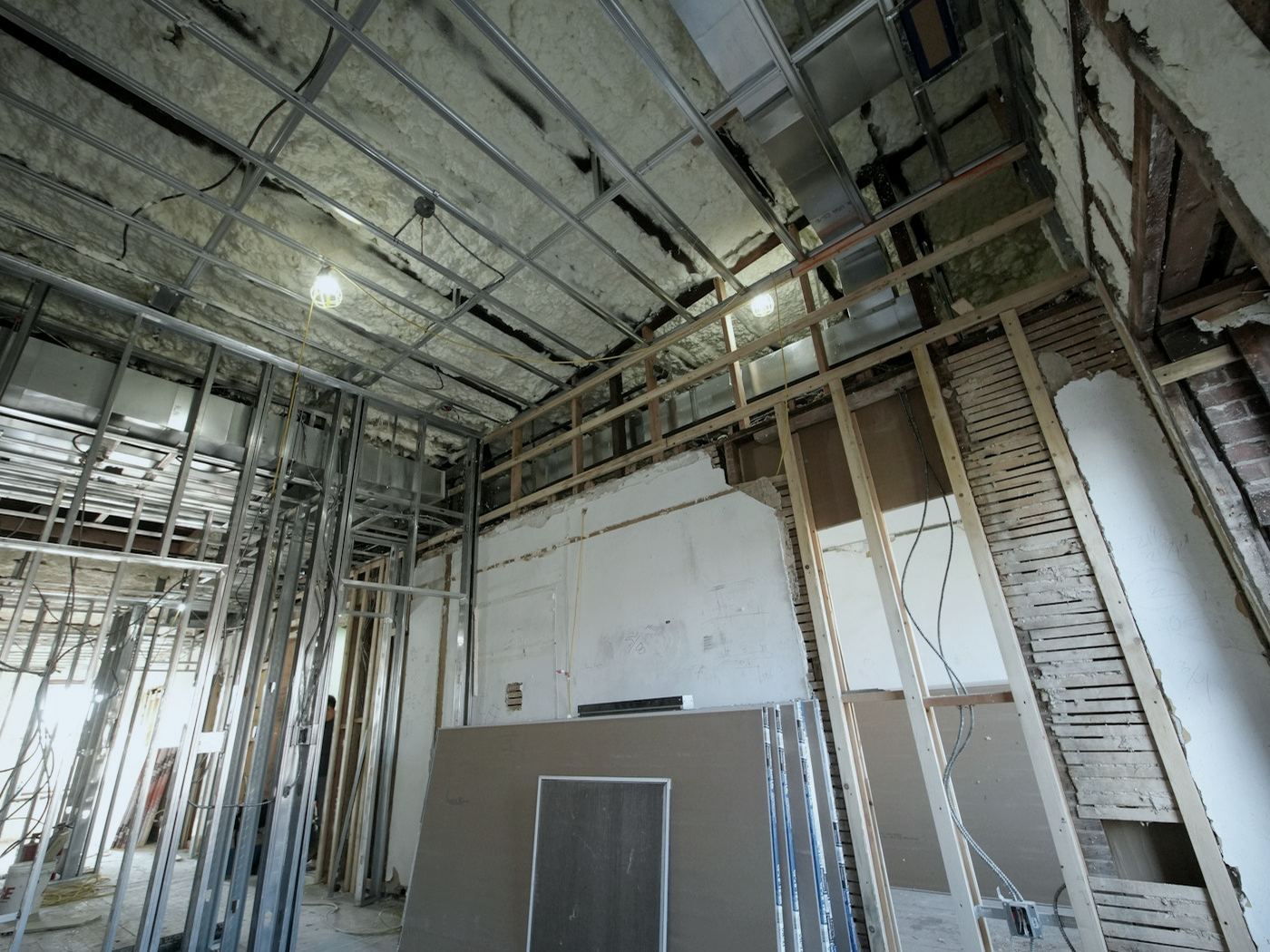 Interior under construction with metal studs and drywall