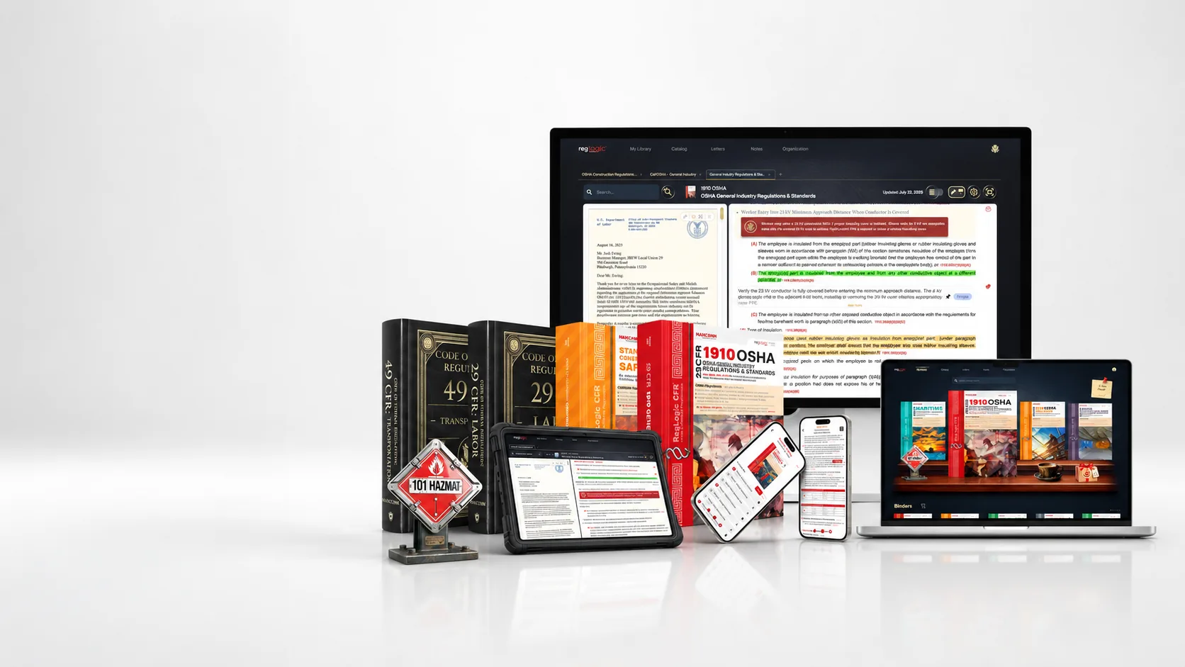 RegLogic on a desktop, laptop, tablet and phones beside Mancomm CFR binders and the 101 Hazmat placard
