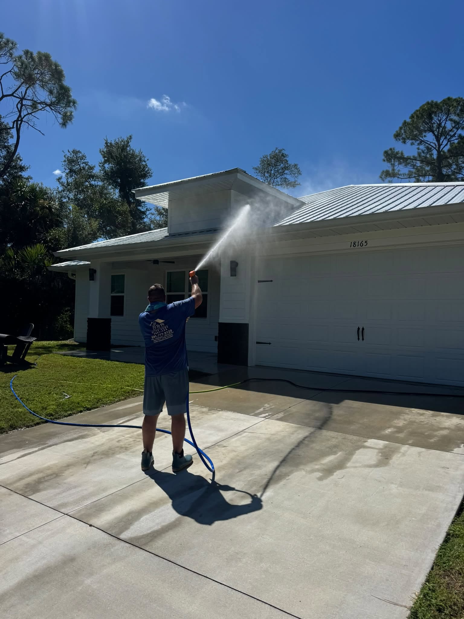 B&B Exterior Services cleaning a pool and lanai at a Southwest Florida home