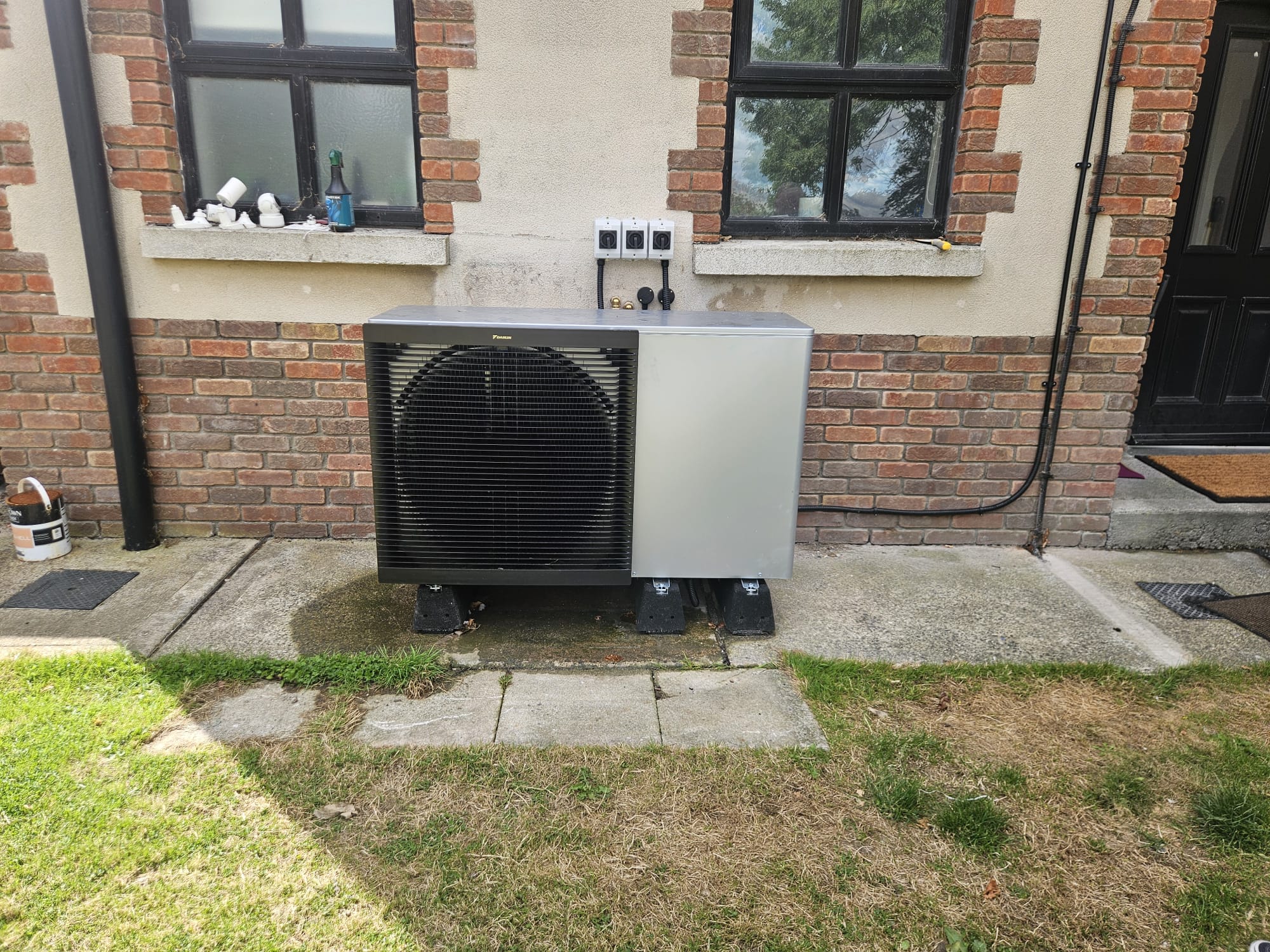 The 16kW Daikin air-to-water heat pump unit installed against the wall of Gerry's home in Ardee