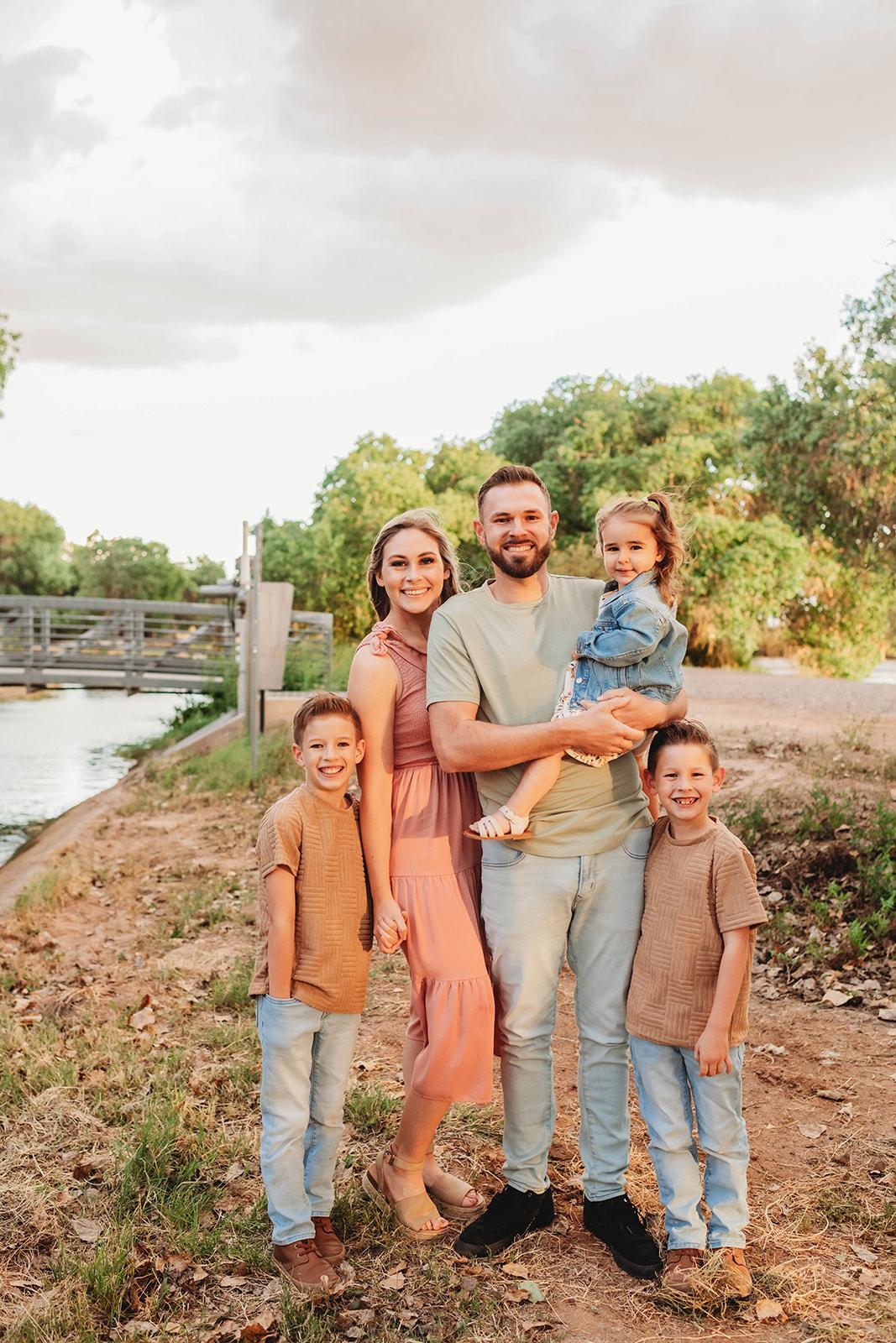 Thomas Contracting owner with his wife and three children in an outdoor family portrait.