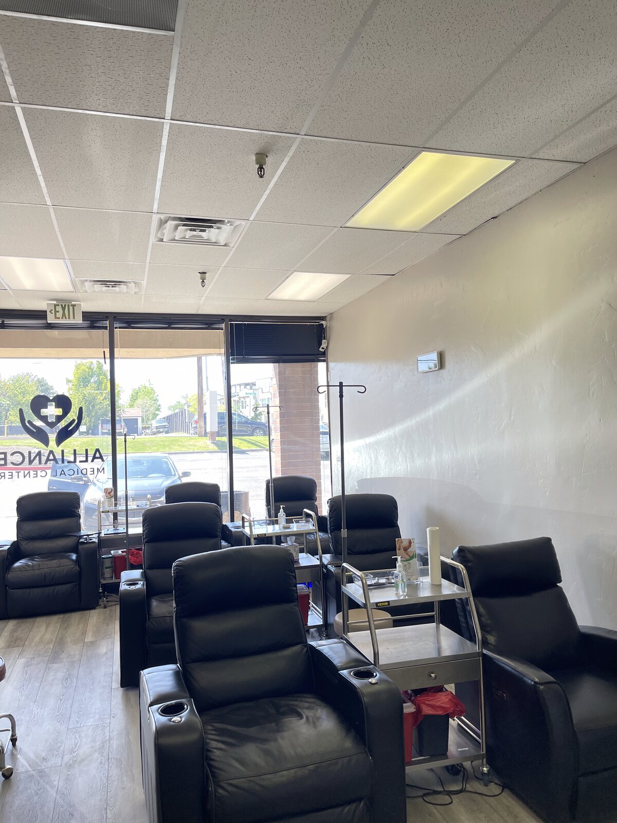 The recovery room at AWRC's Murray, UT clinic — leather IV recliners with natural light from full-height windows.