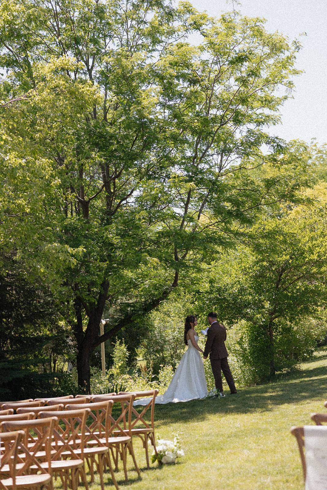 Outdoor ceremony beneath the trees at Stone Crossing