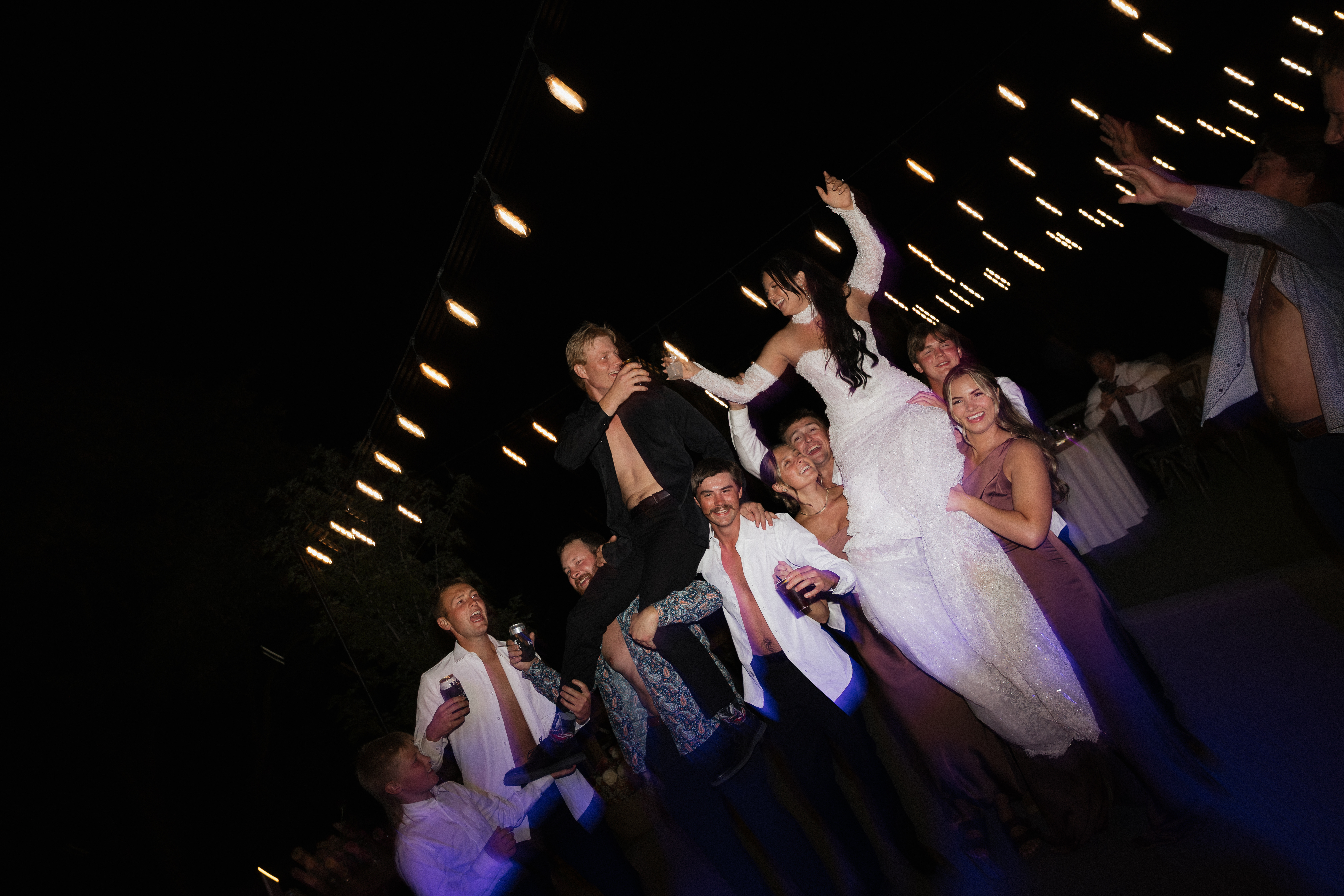 Wedding reception beneath string lights at Stone Crossing
