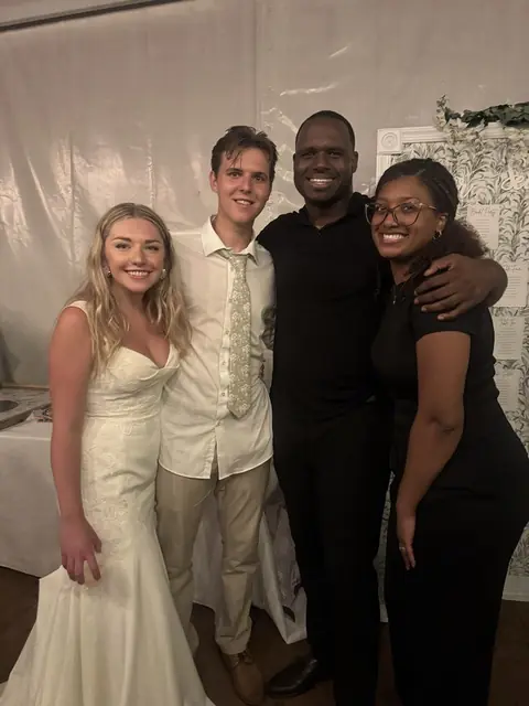 David and Mycheal with a bride and groom on their wedding day