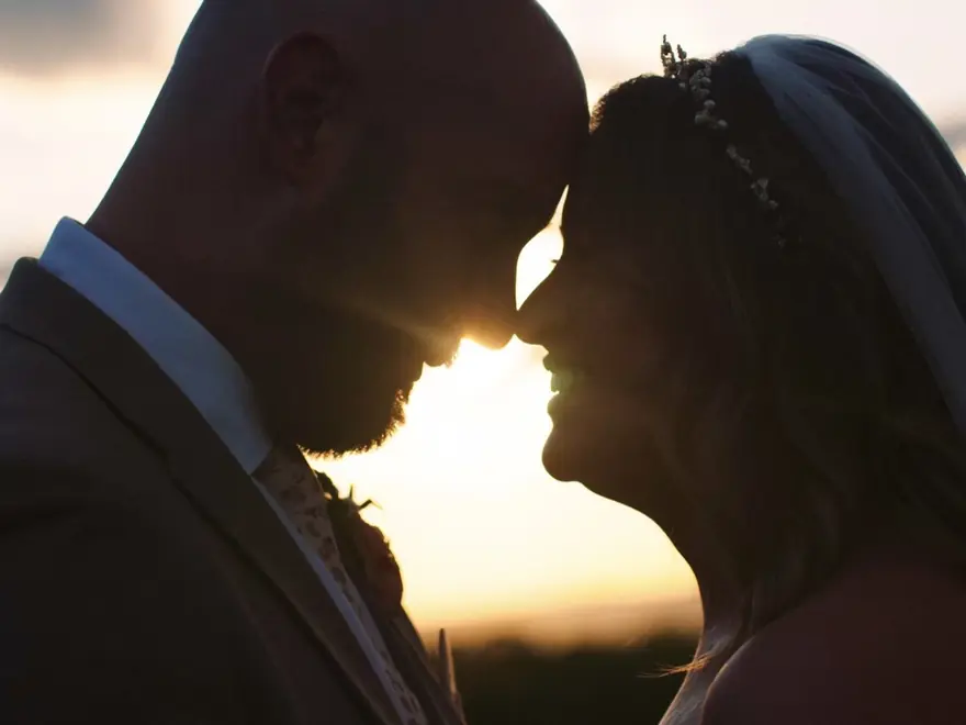 A couple at sunset on their wedding day