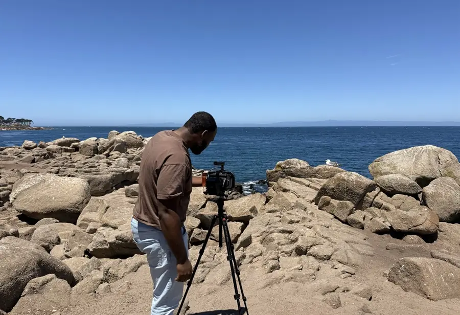 David of D3 Cinema setting up a camera on the coast