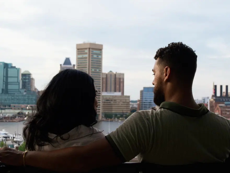 A couple looking out over the city during an engagement shoot