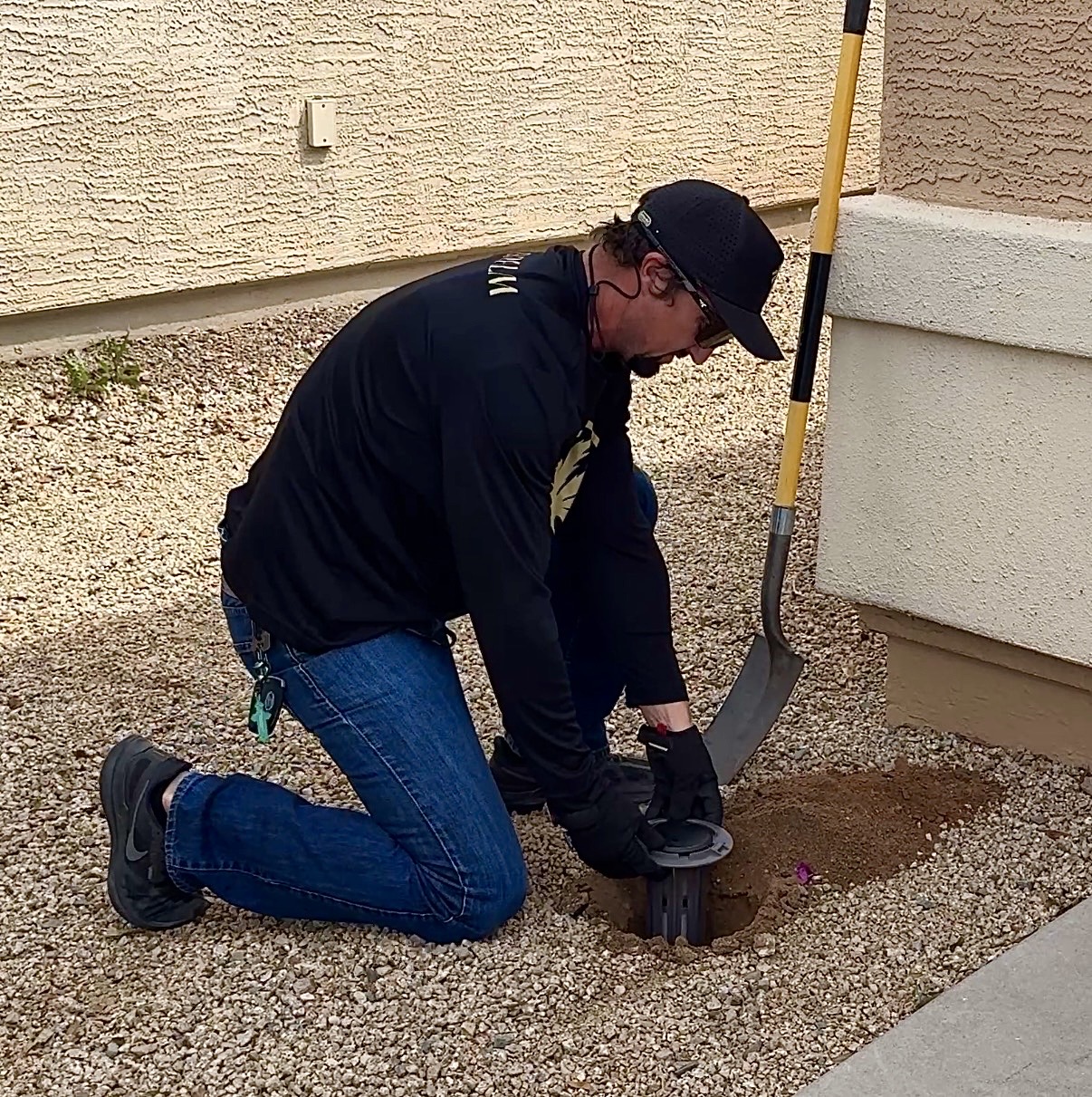 Installing termite bait station in Arizona yard