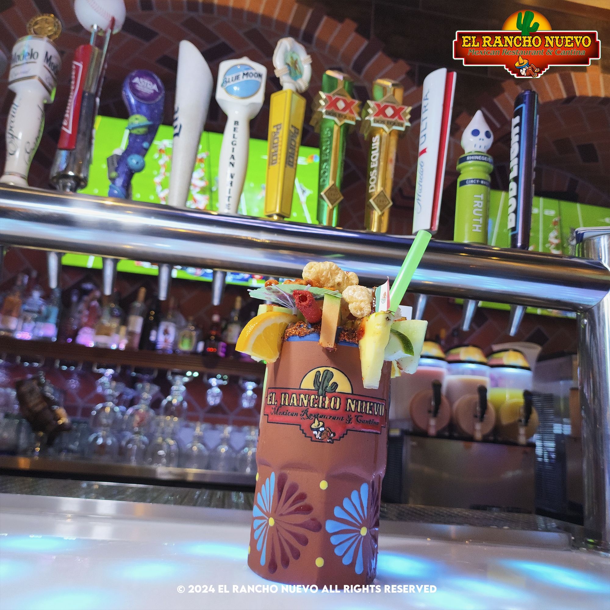 Branded El Rancho Nuevo clay cantarito cocktail with fruit garnish at the bar
