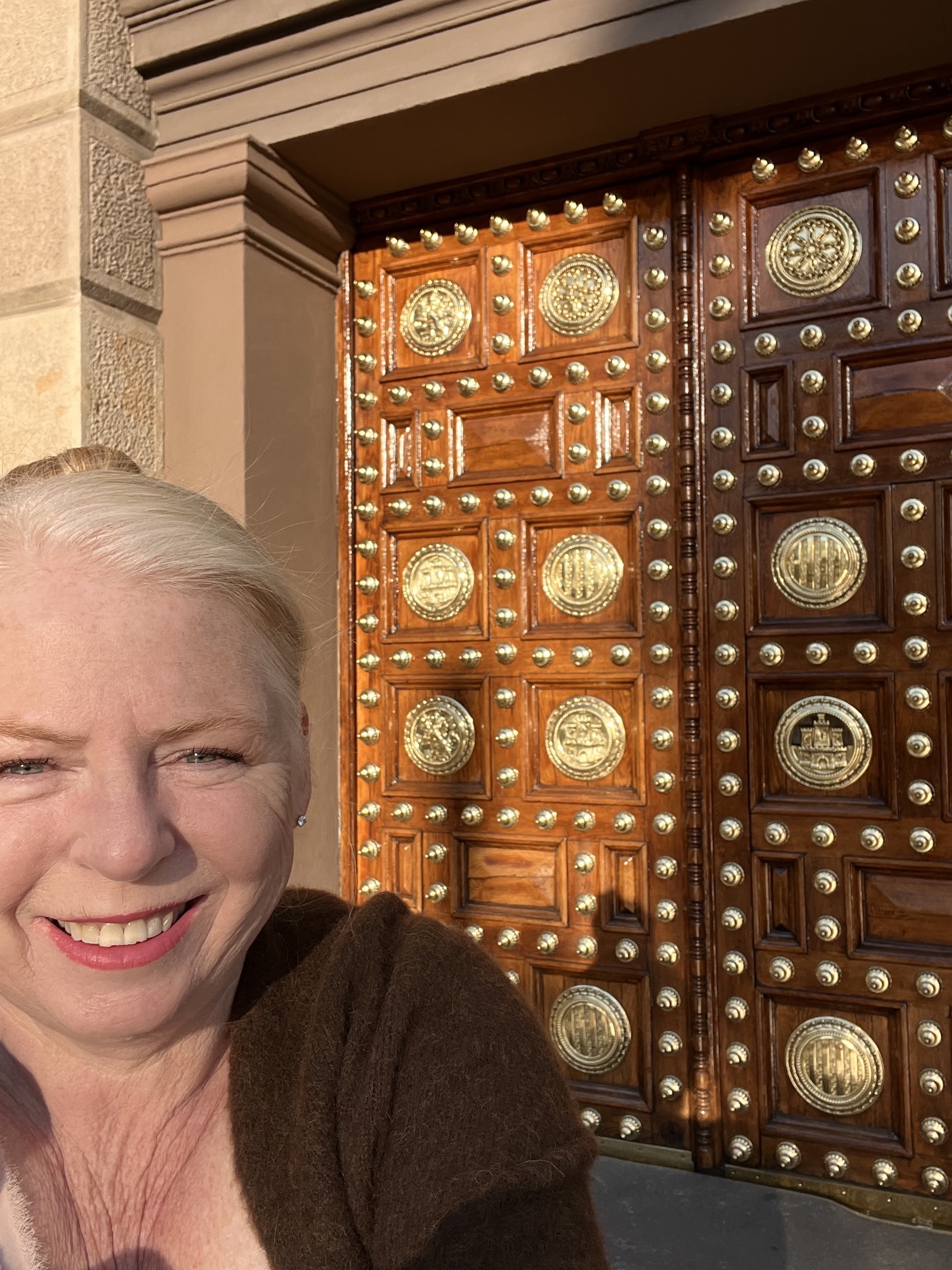 older woman in front of moorish door