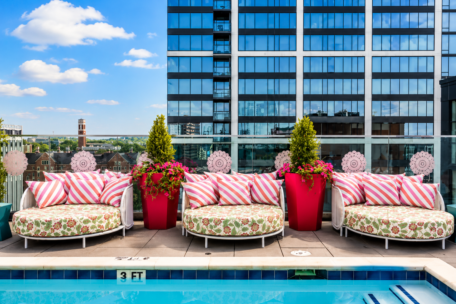 Pink striped daybeds by the rooftop pool