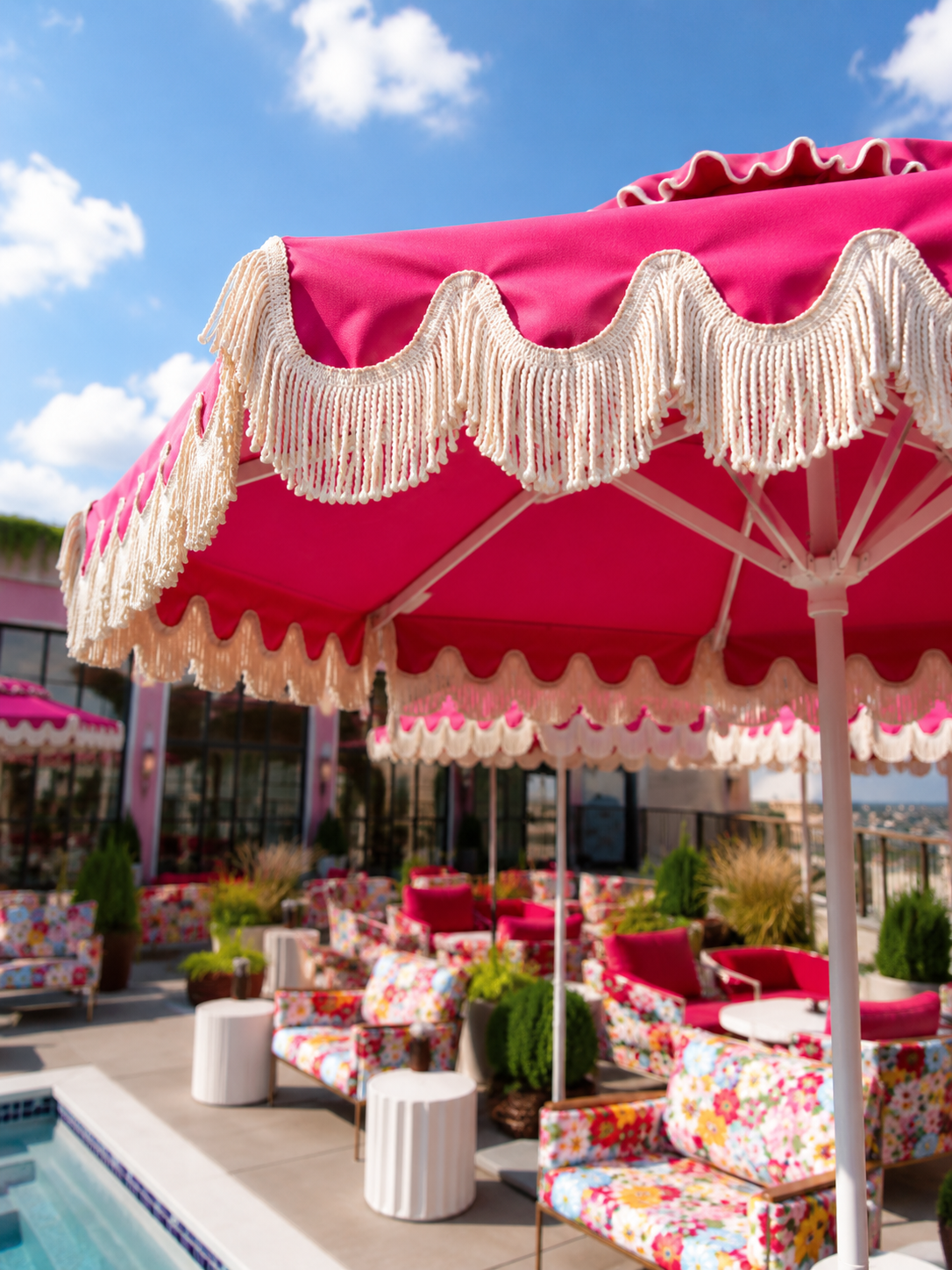 Pink fringed umbrellas on the rooftop pool deck