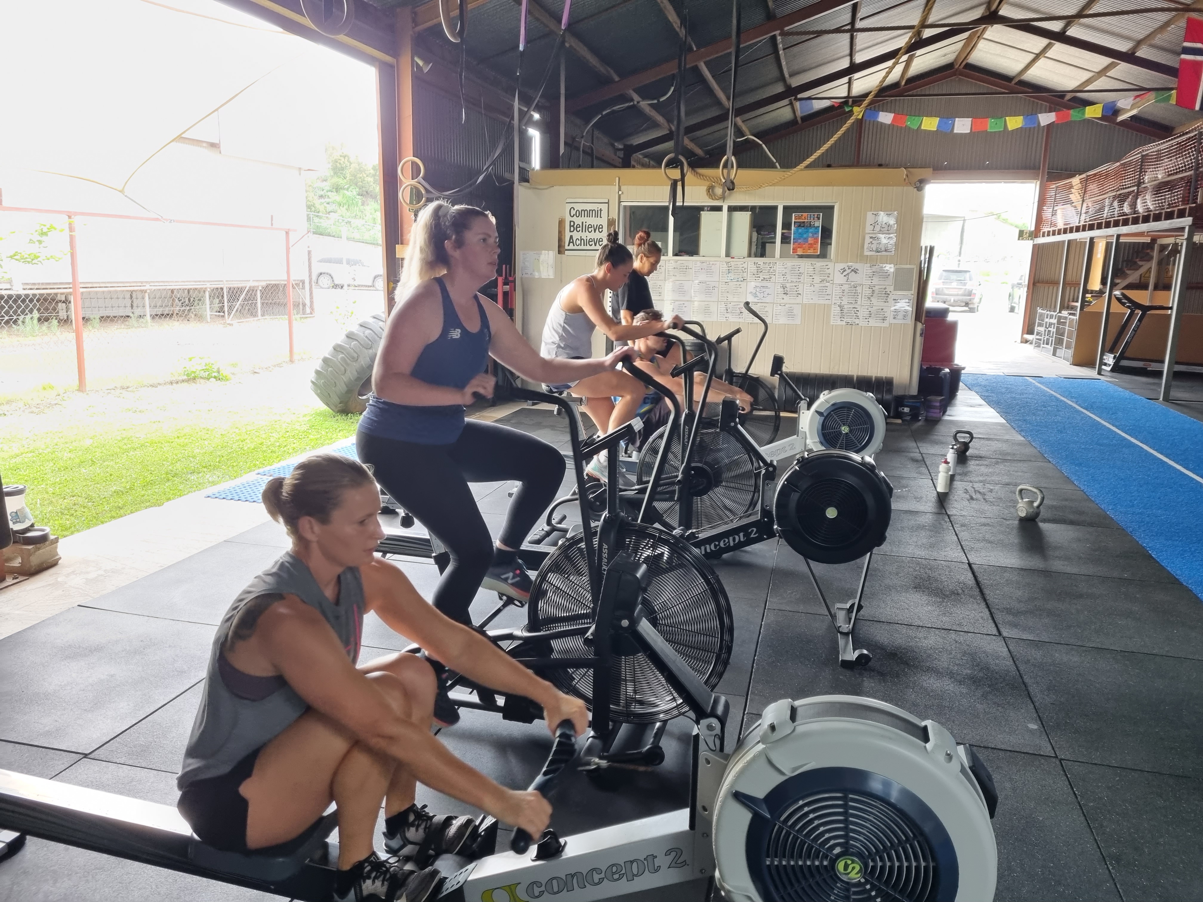 Coach guiding a member through a lift at DropBear CrossFit
