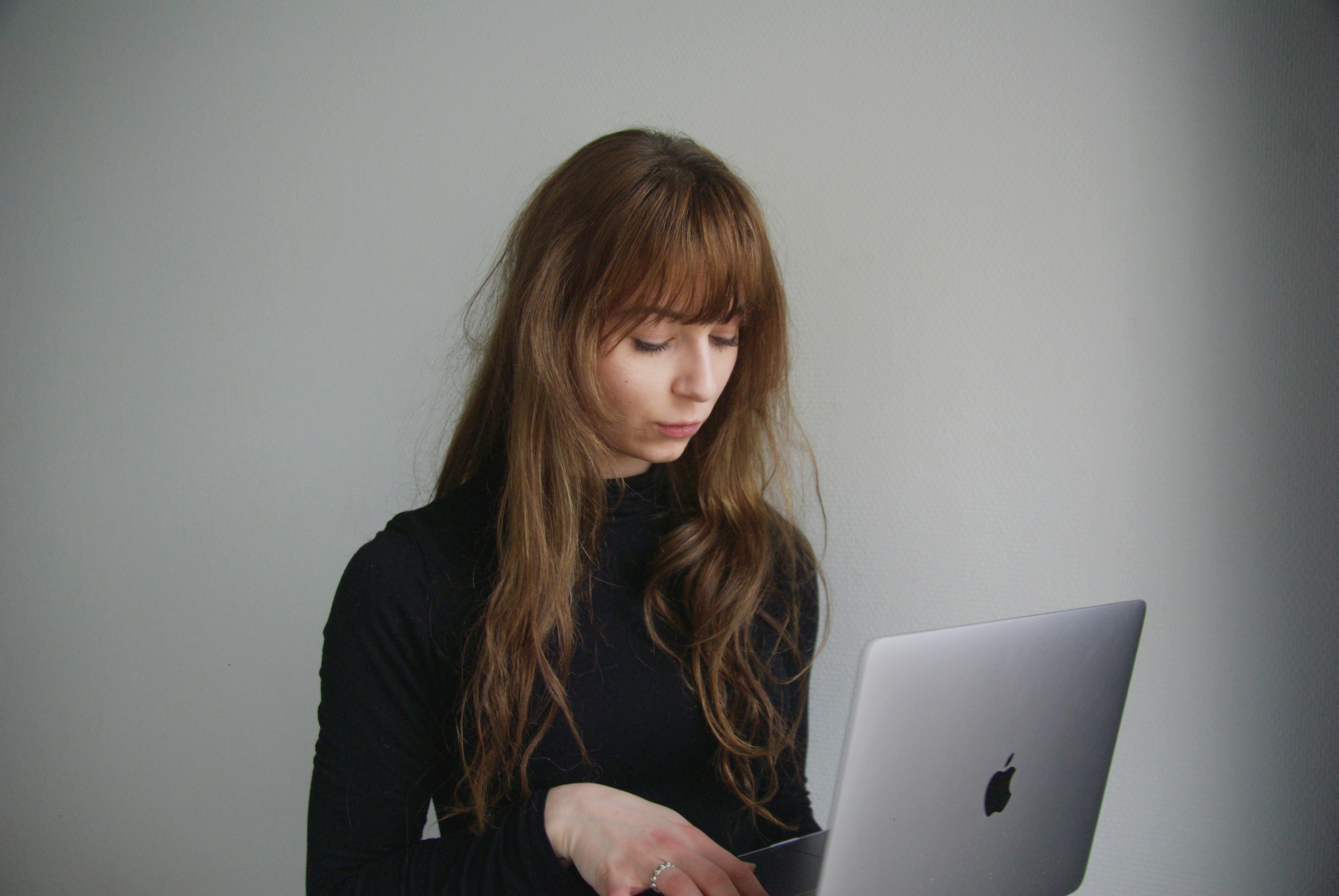 Woman working at a desk with laptop and coffee