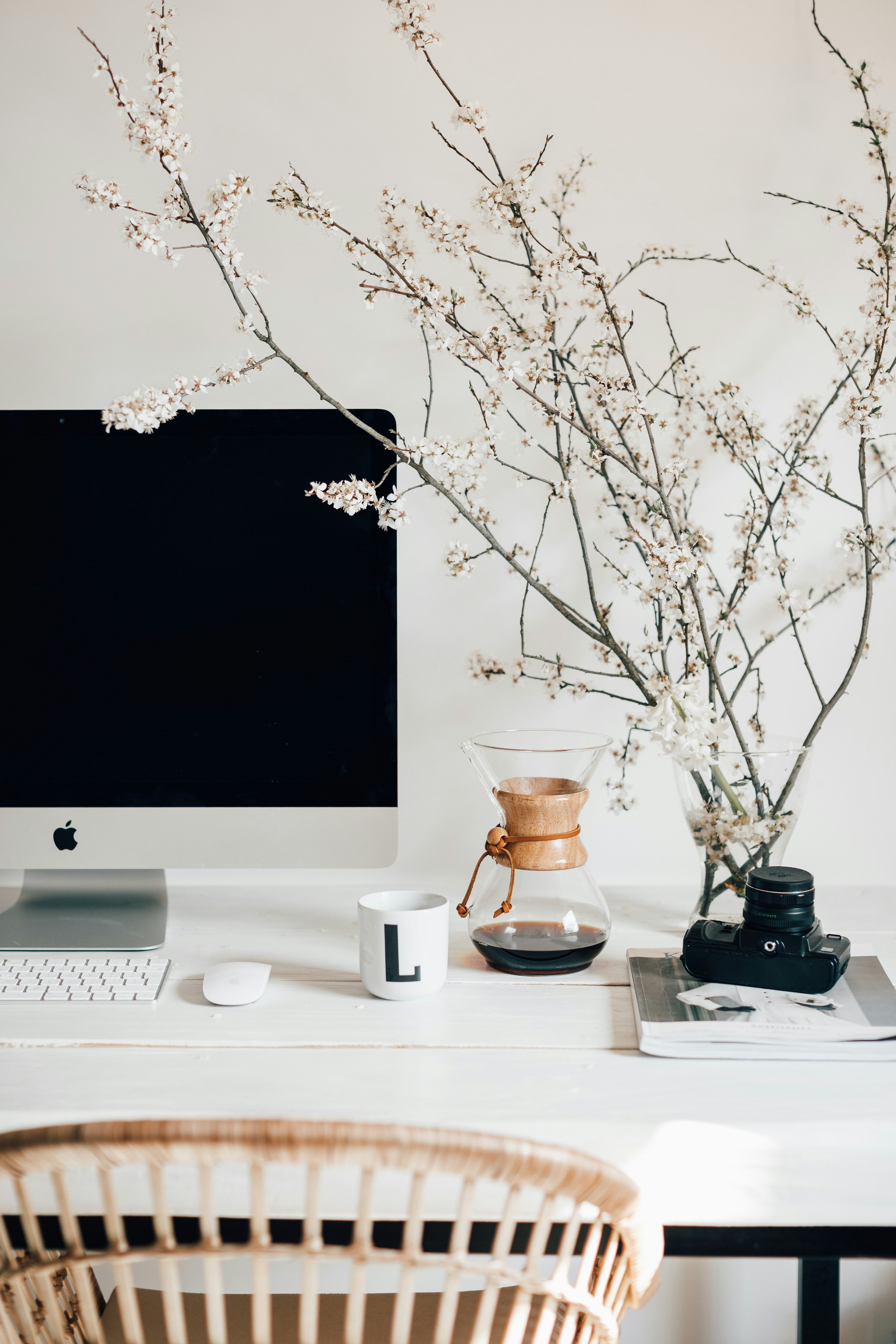 Bright modern desk with computer and flowering branches