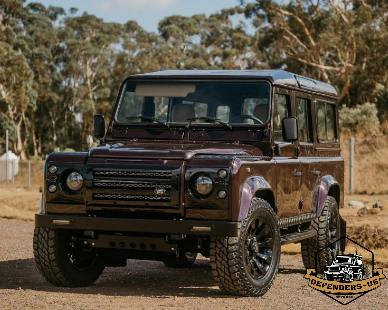 A partially assembled Land Rover Defender suv in a workshop, undergoing restoration or customization.