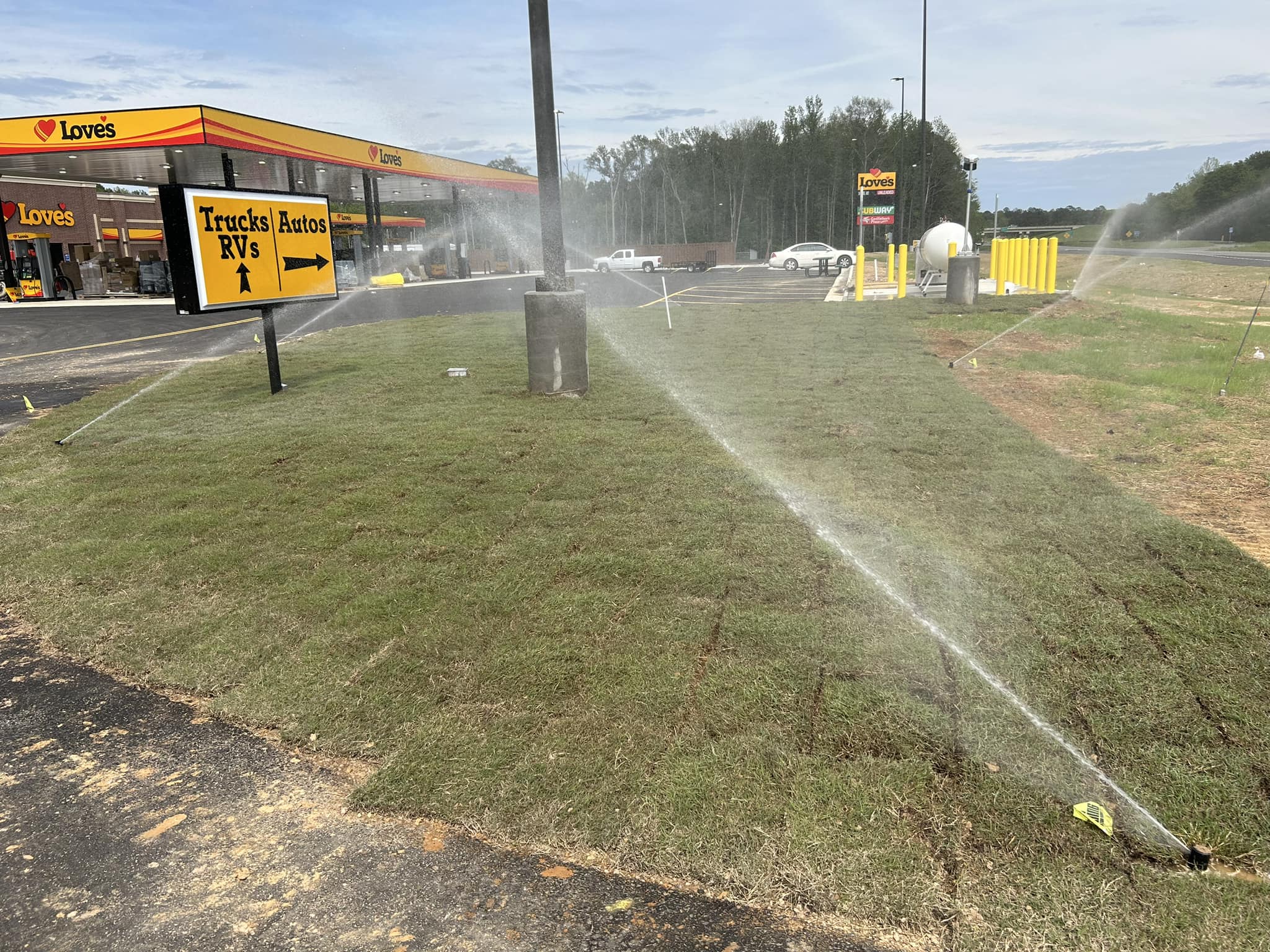 Sprinklers watering fresh sod at a business in Northeast Louisiana
