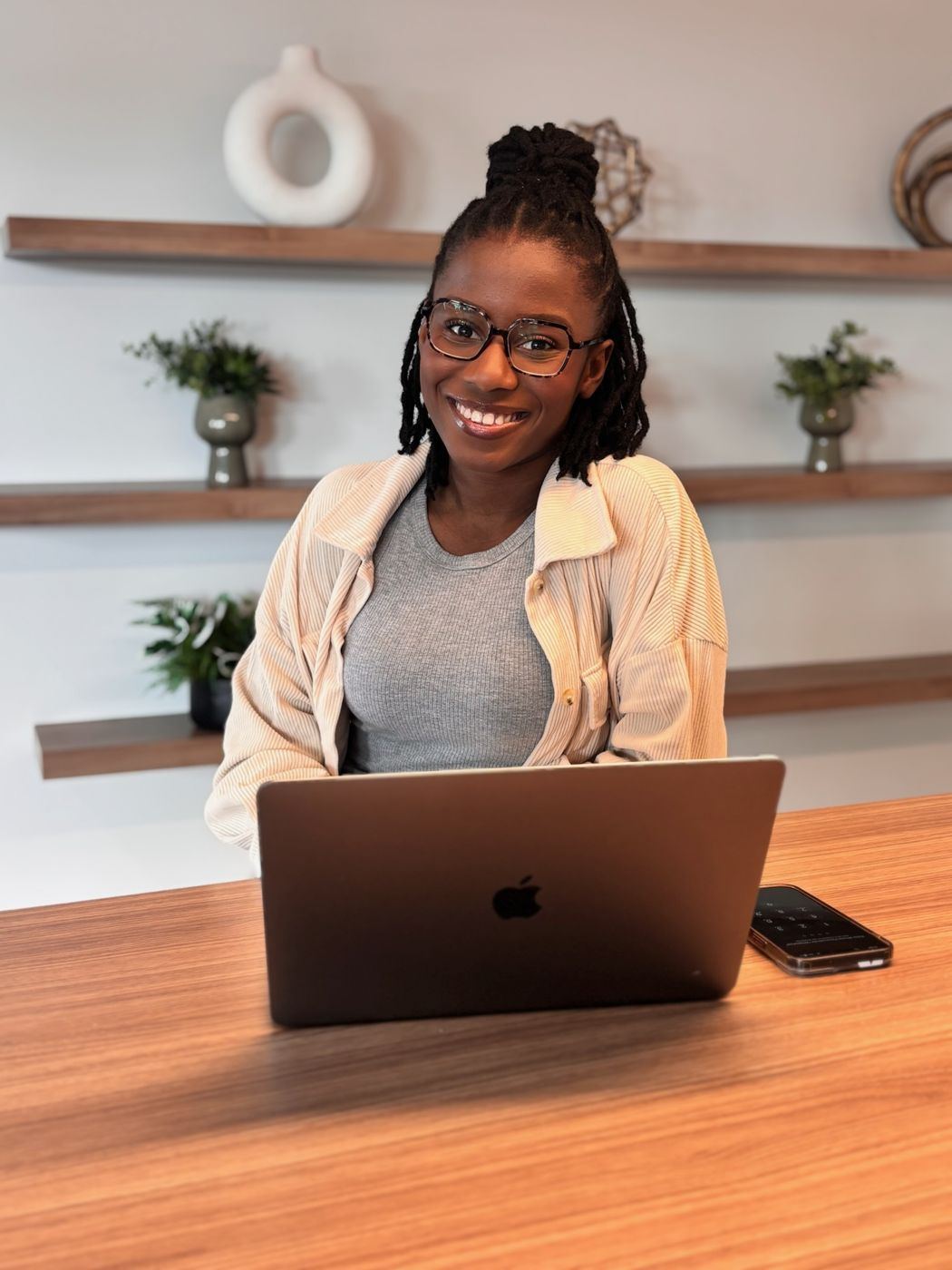 Wildiah Edouard smiling at her laptop